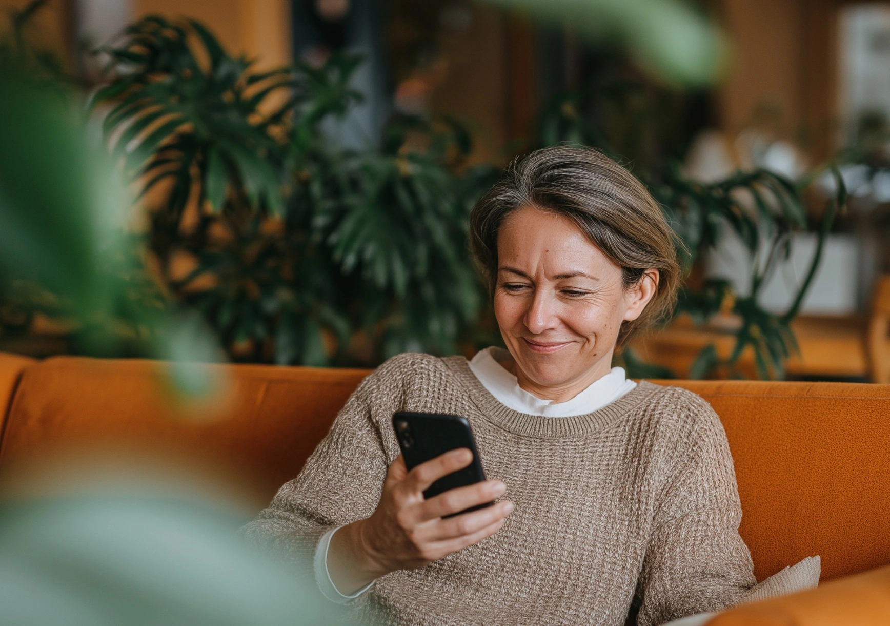 Patiente lisant sur son téléphone l'invitation à préparer son rendez-vous